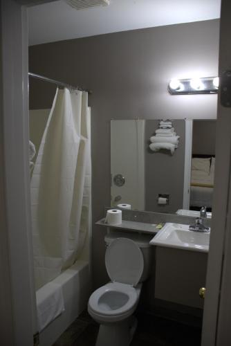 a bathroom with a white toilet and a sink at Rainbow INN in Terrace