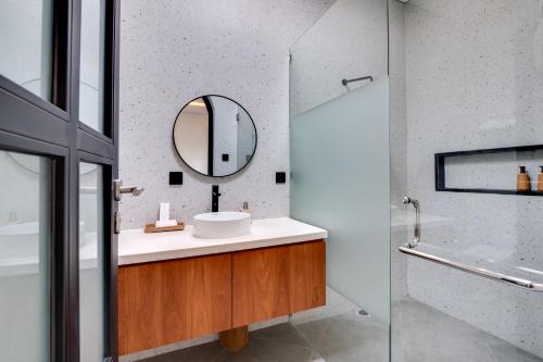 a bathroom with a sink and a mirror at Tresna Villa Tumbak Bayuh Utara in Dalung