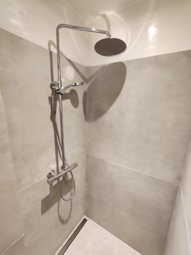 a shower in a bathroom with a ceiling at JP Apartment Floor 1 in Grindsted