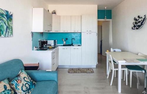 a kitchen and a living room with a couch and a table at Bilo Panorama in Castelsardo