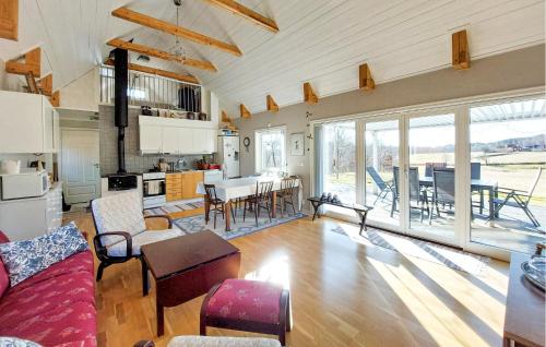 a large living room with a couch and a table at Amazing Home In Slättåkra in Slättåkra