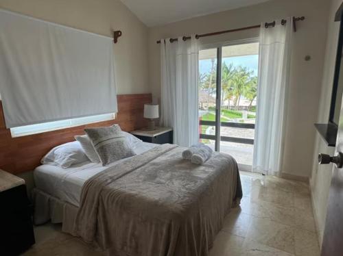 a bedroom with a bed and a large window at Tropical Oasis with Pool Perfect Vacation Home in Puerto Morelos