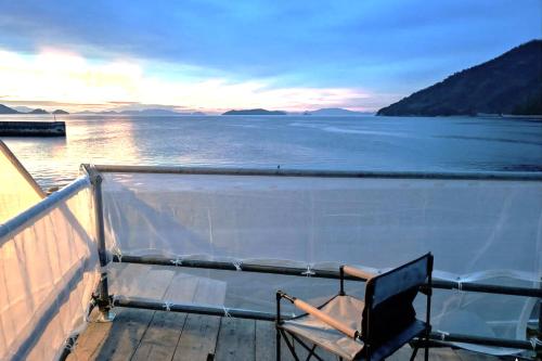 a chair sitting on the deck of a boat at Tiny House ZEN 倉橋島 in Kure
