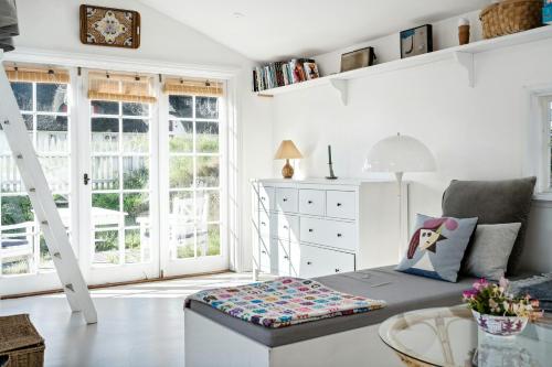 a living room with a couch and a table at Charming Tiny House In Sønderho in Fanø