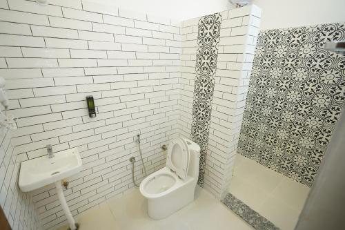 a bathroom with a toilet and a sink at Yelagiri castle in Yelagiri