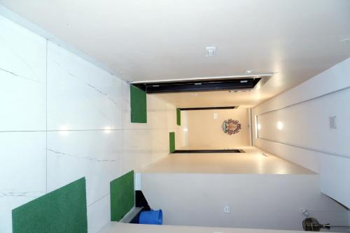 a bathroom with a white and green wall at Hotel Pujari in Khātu
