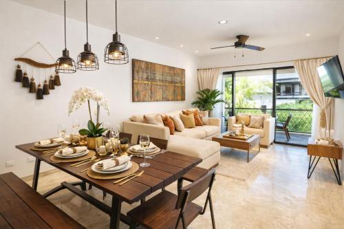 a living room with a table and a couch at Casa Vibe PH- Private Rooftop - 3 Balcony - Pool in Tulum