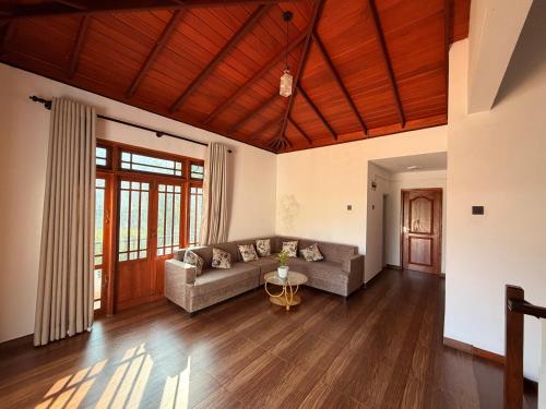 a living room with a couch and a table at Rolling Hills Retreat in Katugastota