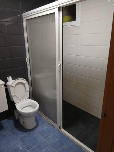 a bathroom with a toilet and a shower stall at Appartement hay lmatar in Nador