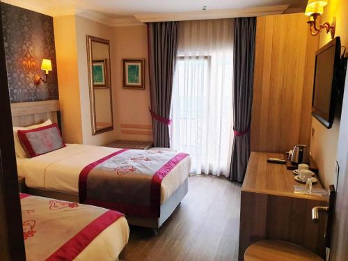 Giường trong phòng chung tại Dab Hotel