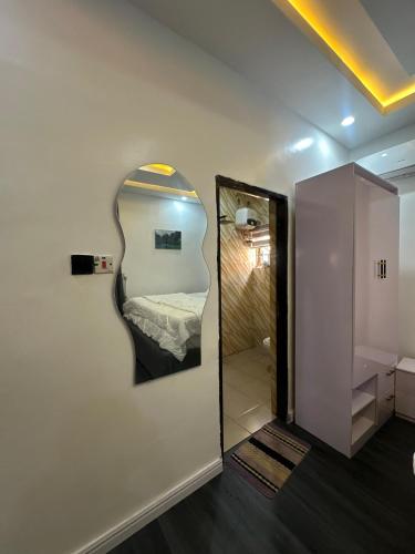a room with a mirror and a room with a bed at EIMACK APARTMENT Service in Asaba