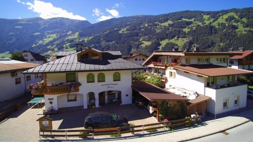 an aerial view of a building with mountains in the background at Ferienwohnungen Flörl in Zell am Ziller