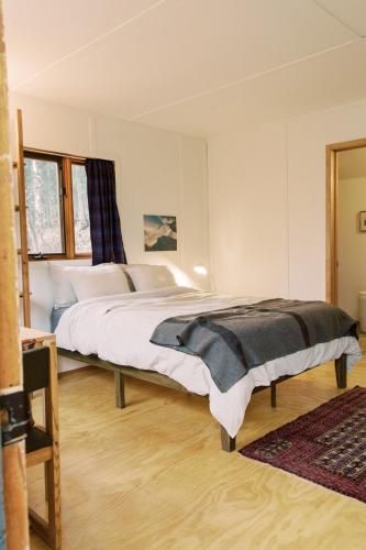 a bedroom with a large bed in a room at Skogstead Cabin in the boreal forest in Fairbanks