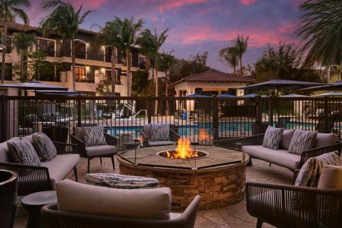 a patio with a fire pit and chairs and a building at Courtyard by Marriott San Luis Obispo in San Luis Obispo