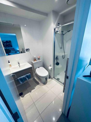 a bathroom with a shower and a toilet and a sink at Urba Residences in Auckland