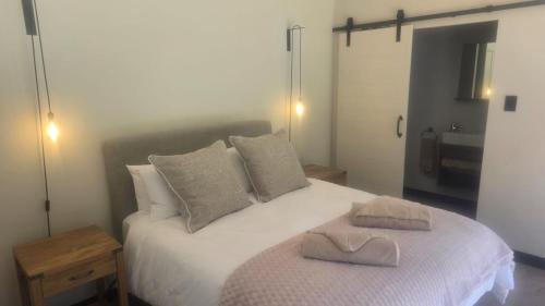 a bedroom with a bed with two towels on it at Tranquility - Cabin nestled in the mountains in Worcester
