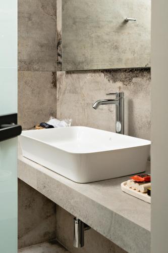 a white sink on a counter in a bathroom at Morfeas Hotel in Chania