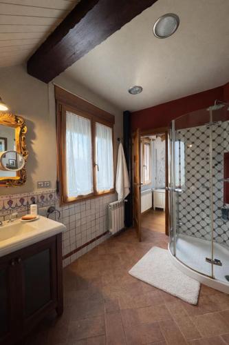 a bathroom with a shower and a sink at Casa Santiago in Argoños