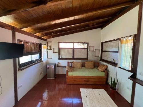 a bedroom with a bed in a small room at L0st & Found House - Casa Bar in Puerto Iguazú