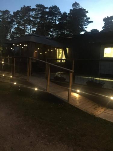 a house at night with lights in front of it at STF Hostel Lärbro/Grannen in Lärbro