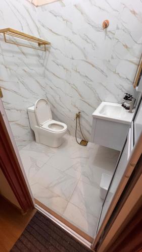a bathroom with a toilet and a sink at Serene Private Villa Kangar in Kangar