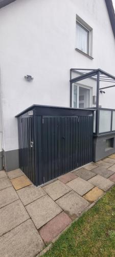 a black gate on the side of a house at Ferienwohnung Odersee in Hattorf