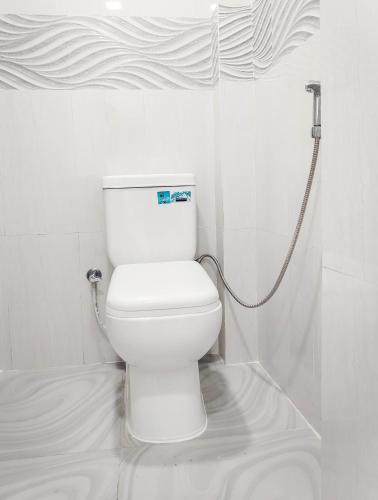 a white toilet in a bathroom with a shower at YK House Midigama in Midigama East