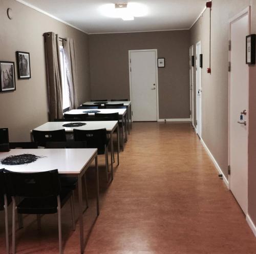 a row of tables and chairs in a room at STF Hostel Lärbro/Grannen in Lärbro