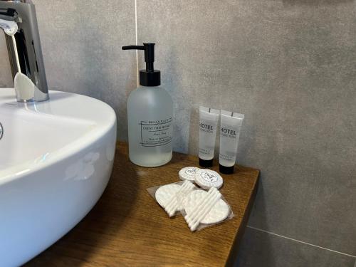 a bathroom with a sink and a bottle of soap at Красник Хілс in Krasnik