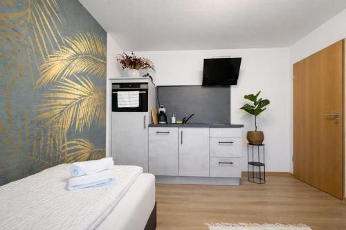 a kitchen with a bed in a room at Deluxe Studio Bella in Backnang