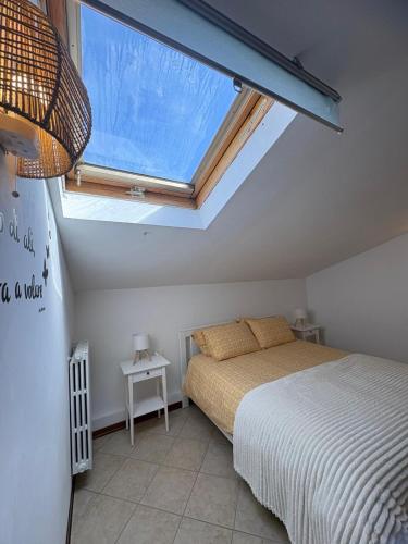 a bedroom with a bed and a large skylight at A casa di Maria in Sulmona