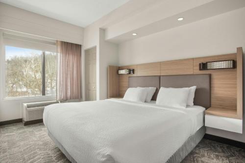 a bedroom with a large white bed and a window at SpringHill Suites by Marriott Morgantown in Morgantown