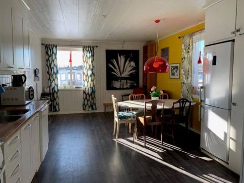 a kitchen and dining room with a table and chairs at Workers Stay - Furnished Housing Umeå Sverige in Klabböle