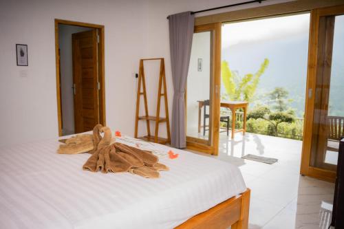 a bedroom with a bed with towels on it at Melaka Hill in Culik