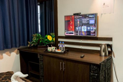 a room with a desk with a tv on top at NAT CITY Hotel in Nuwara Eliya