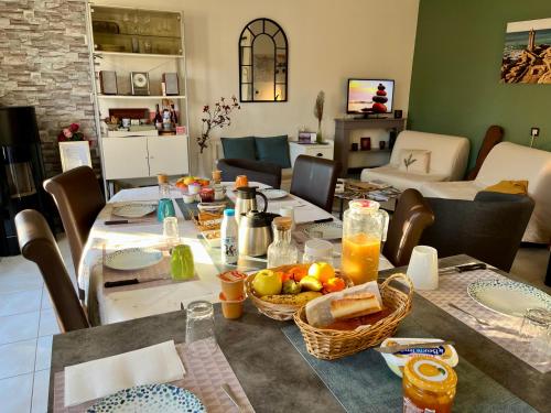 a dining room with a table with food on it at Greg House 49 - Chambres d'Hôtes in Beaupréau