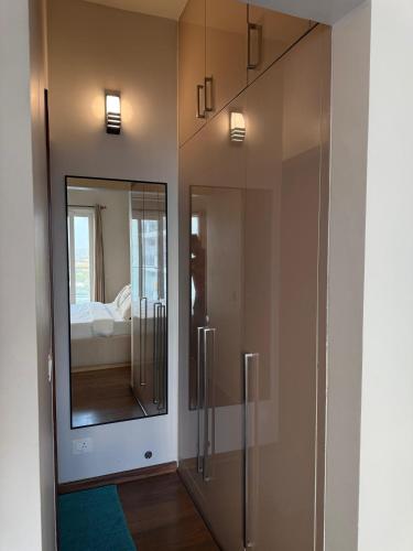 a room with a mirror and a room with a bed at Central Park, The Rooms 1 & 2 BHK Poolview Suites in Gurgaon