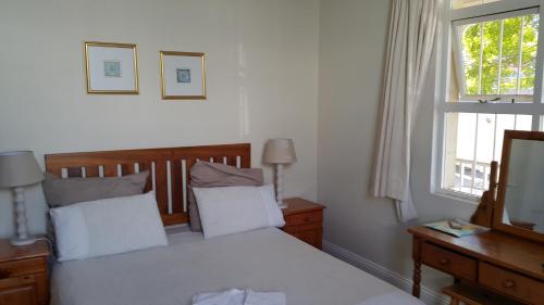 a bedroom with a bed and a window at Sommersby Bed & Breakfast in Durban