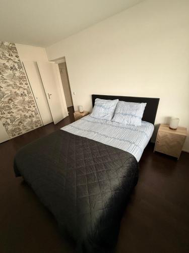 a bedroom with a large black bed in a room at 1 bedroom appartement in the center of Rotterdam in Rotterdam