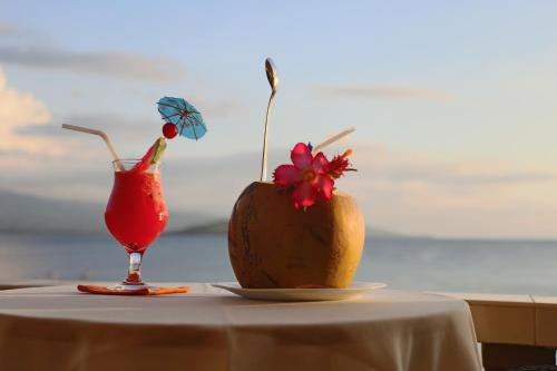 a melon and a drink on a table at Turtle Bay Dive Resort in Moalboal