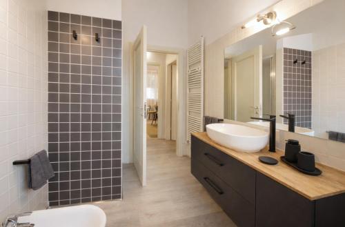 a bathroom with a white sink and a mirror at Ca' Dei Coppi in Solignano Nuovo