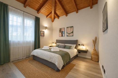 a bedroom with a bed and a large window at Ca' Dei Coppi in Solignano Nuovo