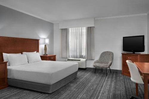 a hotel room with a bed and a television at TownePlace Suites by Marriott Tucson Williams Centre in Tucson