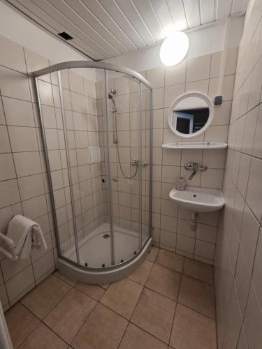 a bathroom with a shower and a sink at Dom Turysty Sanok in Sanok