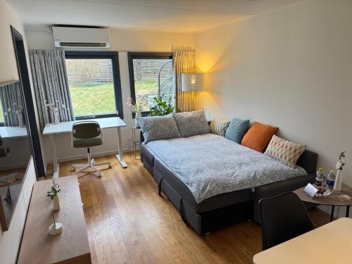 a bedroom with a bed and a desk in it at Brand New Charming Nordic Home for 6 - Near Copenhagen in Farum