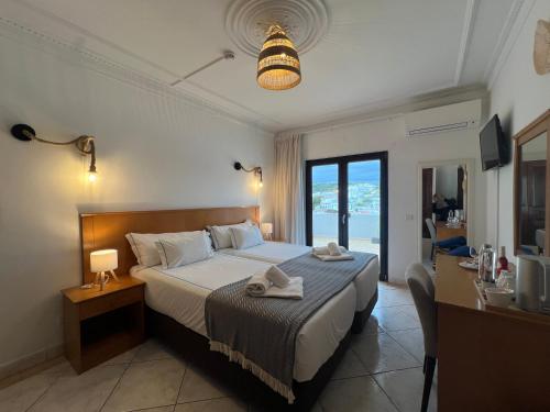a bedroom with a bed with towels on it at ETHOS Bertolina Wellness Urban Living in Albufeira