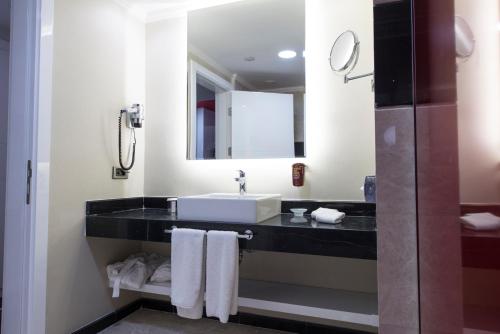 a bathroom with a sink and a mirror at Park Inn by Radisson Ankara Cankaya in Ankara