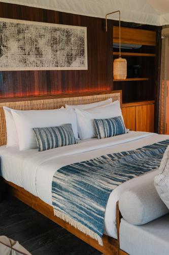 a large bed with pillows on a boat at ARNA Suites and Ocean Lounge in Nusa Lembongan