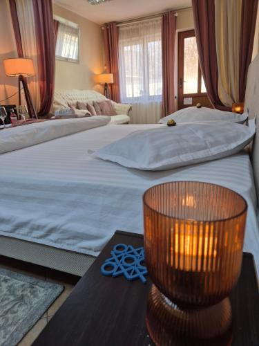 a bedroom with two beds and a table with a orb on it at Ava Studio in Cisnădie