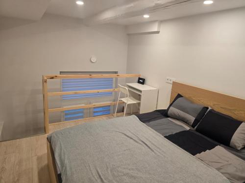 a bedroom with a bed and a desk at A&A Apartment Vilnius 2 in Vilnius